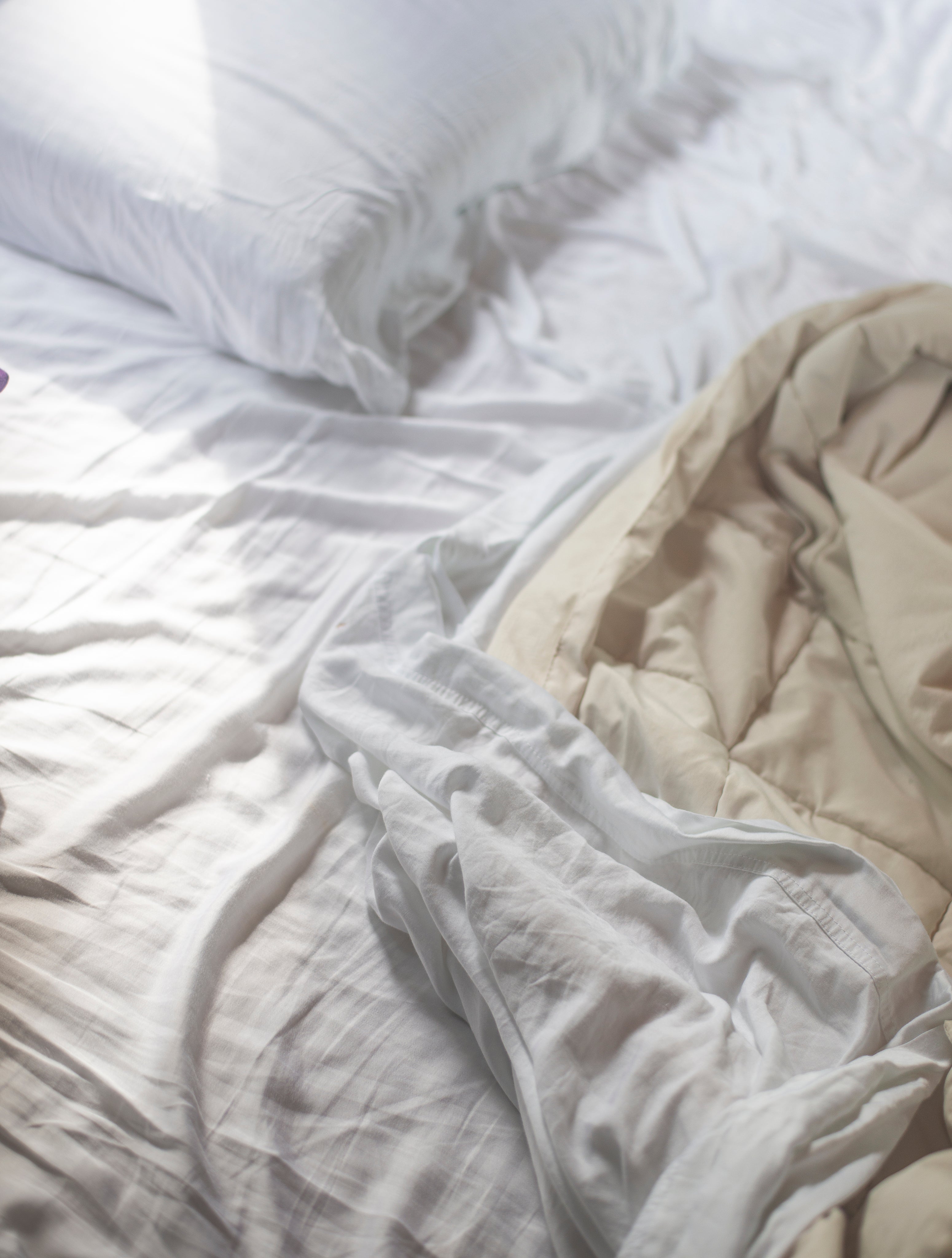white-pillows-and-sheets-on-an-unmade-bed.jpg